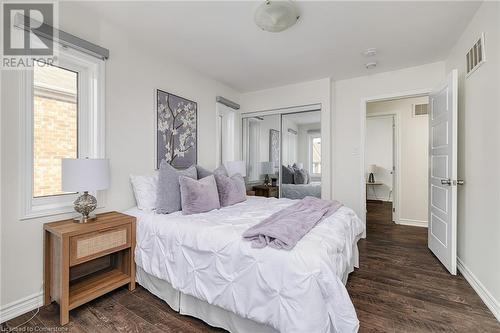 Bedroom featuring a closet, dark hardwood / wood-style floors, and multiple windows - 577 Goldenrod Lane, Kitchener, ON - Indoor Photo Showing Bedroom