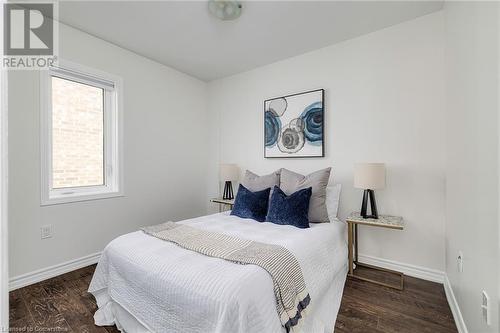 Bedroom featuring dark wood-type flooring - 577 Goldenrod Lane, Kitchener, ON - Indoor Photo Showing Bedroom