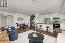 Living room with dark hardwood / wood-style flooring and sink - 