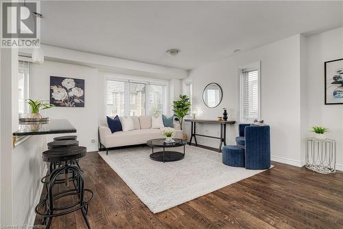 Living room with dark hardwood / wood-style floors and plenty of natural light - 577 Goldenrod Lane, Kitchener, ON - Indoor Photo Showing Living Room