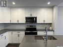 16 525 Mahabir Lane, Saskatoon, SK  - Indoor Photo Showing Kitchen With Stainless Steel Kitchen With Double Sink With Upgraded Kitchen 