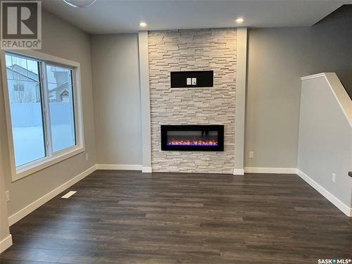 16 525 Mahabir Lane, Saskatoon, SK - Indoor Photo Showing Other Room With Fireplace