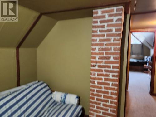 Original brick exposed on second level - 807 Oscar Street, Revelstoke, BC - Indoor Photo Showing Bedroom