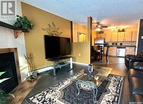 521 2406 Heseltine Road, Regina, SK - Indoor Photo Showing Living Room With Fireplace