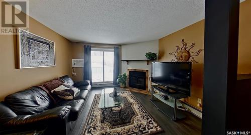 521 2406 Heseltine Road, Regina, SK - Indoor Photo Showing Living Room With Fireplace