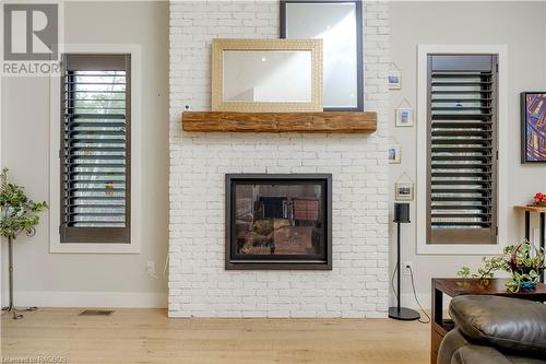 Living room with a fireplace and light hardwood / wood-style flooring - 33 Madwayosh Street, Southampton, ON - Indoor With Fireplace