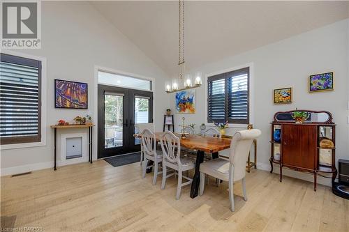 Dining space with a notable chandelier, french doors, high vaulted ceiling, and light hardwood / wood-style flooring - 33 Madwayosh Street, Southampton, ON - Indoor Photo Showing Dining Room