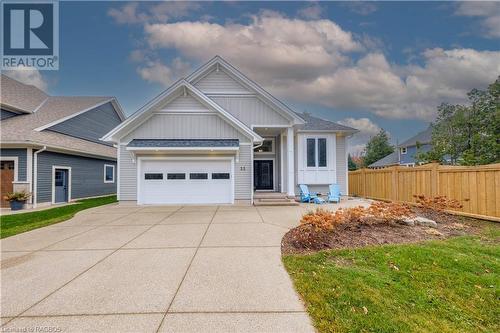 View of front of house with a front yard and a garage - 33 Madwayosh Street, Southampton, ON - Outdoor With Facade