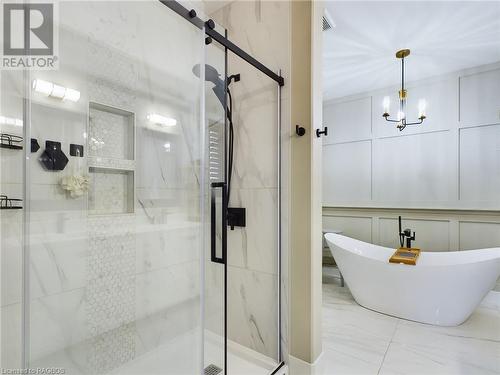 Bathroom featuring separate shower and tub and a notable chandelier - 33 Madwayosh Street, Southampton, ON - Indoor Photo Showing Bathroom