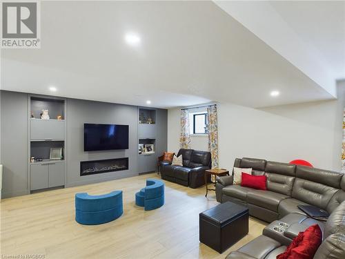 Living room featuring light wood-type flooring - 33 Madwayosh Street, Southampton, ON - Indoor With Fireplace