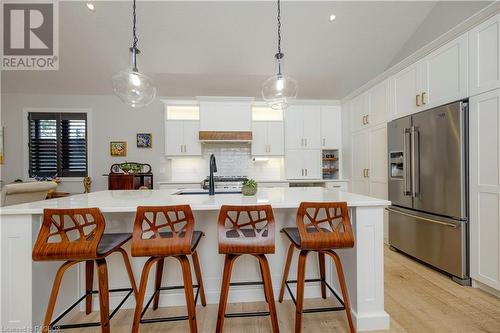 Kitchen featuring white cabinets, a kitchen island with sink, and high end refrigerator - 33 Madwayosh Street, Southampton, ON - Indoor Photo Showing Kitchen