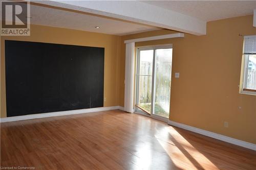 Empty room with a textured ceiling, light hardwood / wood-style flooring, and a wealth of natural light - 147 Weber Street E, Kitchener, ON - Indoor Photo Showing Other Room