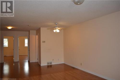 Spare room featuring hardwood / wood-style floors, a textured ceiling, and ceiling fan - 147 Weber Street E, Kitchener, ON - Indoor Photo Showing Other Room