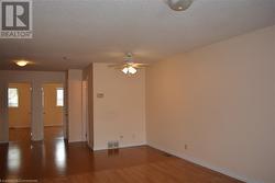 Spare room featuring hardwood / wood-style floors, a textured ceiling, and ceiling fan - 