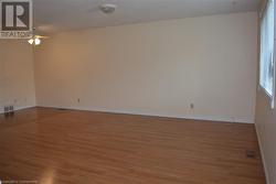 Unfurnished room featuring ceiling fan and light hardwood / wood-style flooring - 