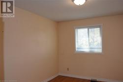 Spare room featuring a textured ceiling and hardwood / wood-style flooring - 