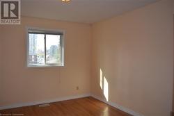 Empty room featuring wood-type flooring - 