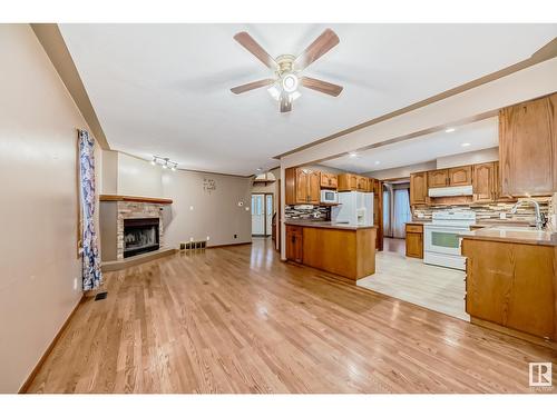 7008 157 Av Nw, Edmonton, AB - Indoor Photo Showing Kitchen With Fireplace With Double Sink