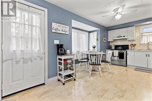 Kitchen with white cabinetry, sink, stainless steel range with electric cooktop, and ceiling fan - 830 Elma Street W, Listowel, ON - Indoor