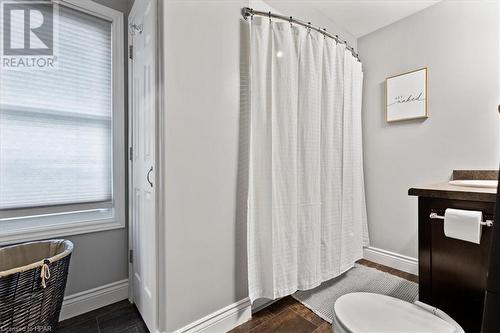 Bathroom featuring walk in shower, toilet, vanity, and hardwood / wood-style flooring - 830 Elma Street W, Listowel, ON - Indoor Photo Showing Bathroom