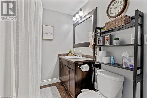 Bathroom with a shower with curtain, vanity, toilet, and wood-type flooring - 830 Elma Street W, Listowel, ON - Indoor Photo Showing Bathroom