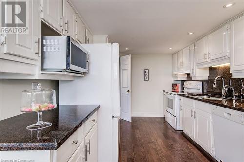 Bright, White Kitchen with Hardwood Floors - 6 Willow Street Unit# #1505, Waterloo, ON - Indoor Photo Showing Kitchen