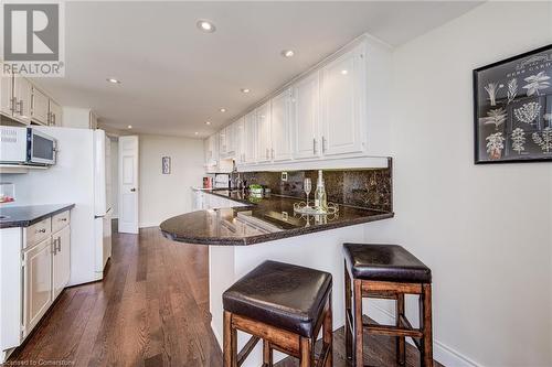 Gleaming Granite Counters with a Breakfast Bar (seats 3) - 6 Willow Street Unit# #1505, Waterloo, ON - Indoor Photo Showing Kitchen