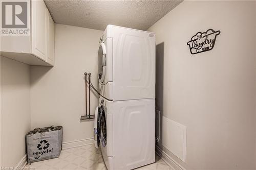 In-Suite Laundry room with upper storage cupboards - 6 Willow Street Unit# #1505, Waterloo, ON - Indoor Photo Showing Laundry Room