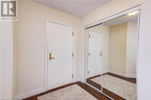 Mirrored Sliding Closet Doors in Foyer - 6 Willow Street Unit# #1505, Waterloo, ON - Indoor Photo Showing Other Room