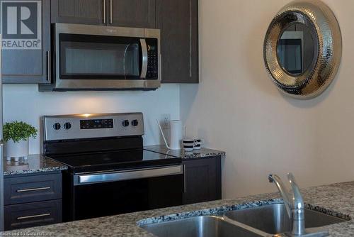 16 Concord Place Unit# 424, Grimsby, ON - Indoor Photo Showing Kitchen With Double Sink