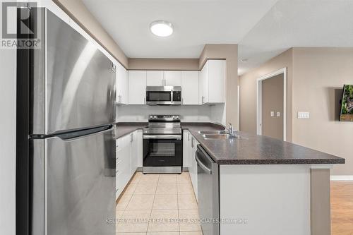 401 - 4879 Kimbermount Avenue, Mississauga, ON - Indoor Photo Showing Kitchen With Stainless Steel Kitchen With Double Sink