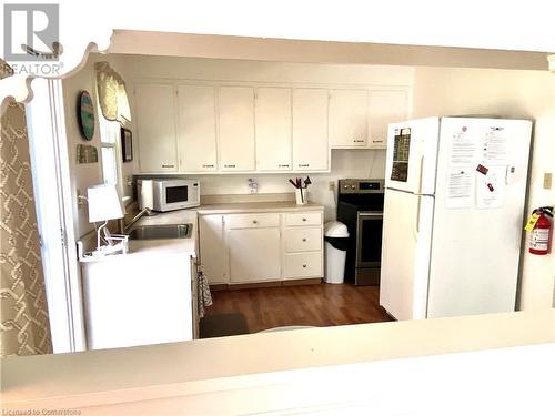 Take a peek...spy on the cook. - 322 Oxford Avenue, Crystal Beach, ON - Indoor Photo Showing Kitchen