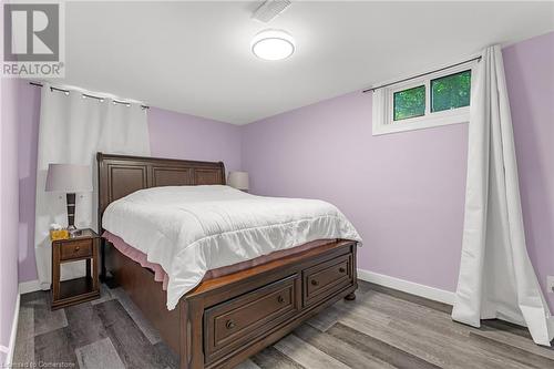 Lower level bedroom with wall electric fireplace - 15414 Niagara River Parkway, Niagara-On-The-Lake, ON - Indoor Photo Showing Bedroom