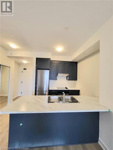 Kitchen w/ Stainless Steel Appliances and Island - 600 North Service Road Unit# 424, Hamilton, ON - Indoor Photo Showing Kitchen With Double Sink