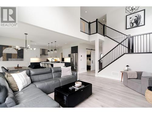 Open concept main floor with soaring ceilings - 4315 Ladd Court, Kelowna, BC - Indoor Photo Showing Living Room