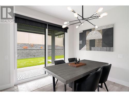 Dining space walks out to the patio and green space - 4315 Ladd Court, Kelowna, BC - Indoor Photo Showing Dining Room