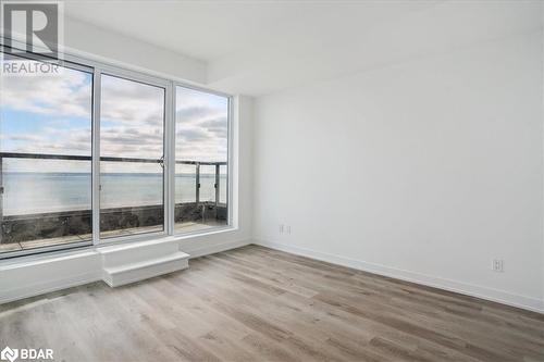 Unfurnished room with a water view, light hardwood / wood-style flooring, and a healthy amount of sunlight - 370 Martha Street Unit# 2104, Burlington, ON - Indoor Photo Showing Other Room