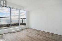 Unfurnished room with a water view, light hardwood / wood-style flooring, and a healthy amount of sunlight - 