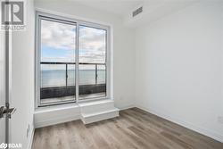 Spare room featuring a water view and light wood-type flooring - 