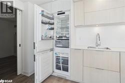 Kitchen featuring wood-type flooring and sink - 