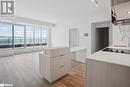 Kitchen with a center island, a water view, sink, light brown cabinetry, and light hardwood / wood-style floors - 370 Martha Street Unit# 2104, Burlington, ON  - Indoor Photo Showing Other Room 