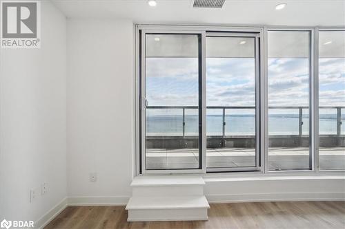 Unfurnished room featuring a water view and wood-type flooring - 370 Martha Street Unit# 2104, Burlington, ON - Indoor Photo Showing Other Room