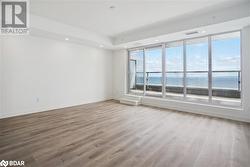 Spare room with hardwood / wood-style flooring and a water view - 