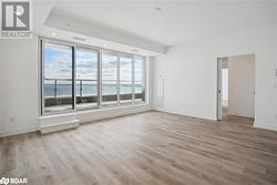 Empty room featuring light hardwood / wood-style floors and a water view - 