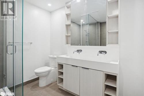 Bathroom with tile patterned floors, a shower with door, vanity, and toilet - 370 Martha Street Unit# 2104, Burlington, ON - Indoor Photo Showing Bathroom