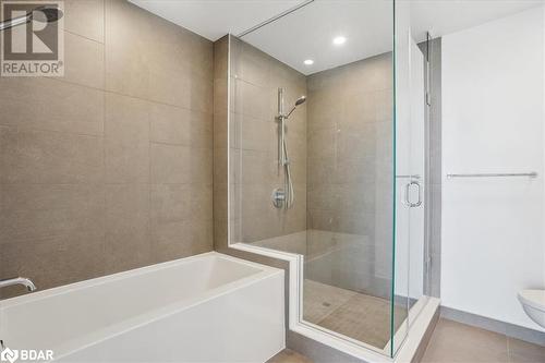 Bathroom with tile patterned flooring, separate shower and tub, and toilet - 370 Martha Street Unit# 2104, Burlington, ON - Indoor Photo Showing Bathroom