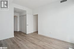 Unfurnished bedroom with light wood-type flooring and a closet - 