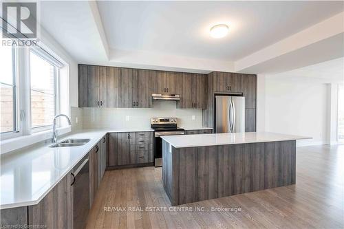 13 - Ul - 2273 Turnberry Road, Burlington, ON - Indoor Photo Showing Kitchen With Stainless Steel Kitchen With Double Sink With Upgraded Kitchen