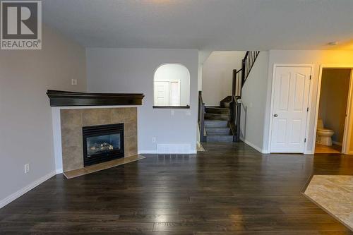 8545 102A Avenue, Grande Prairie, AB - Indoor Photo Showing Living Room With Fireplace