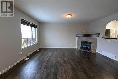 8545 102A Avenue, Grande Prairie, AB - Indoor Photo Showing Living Room With Fireplace